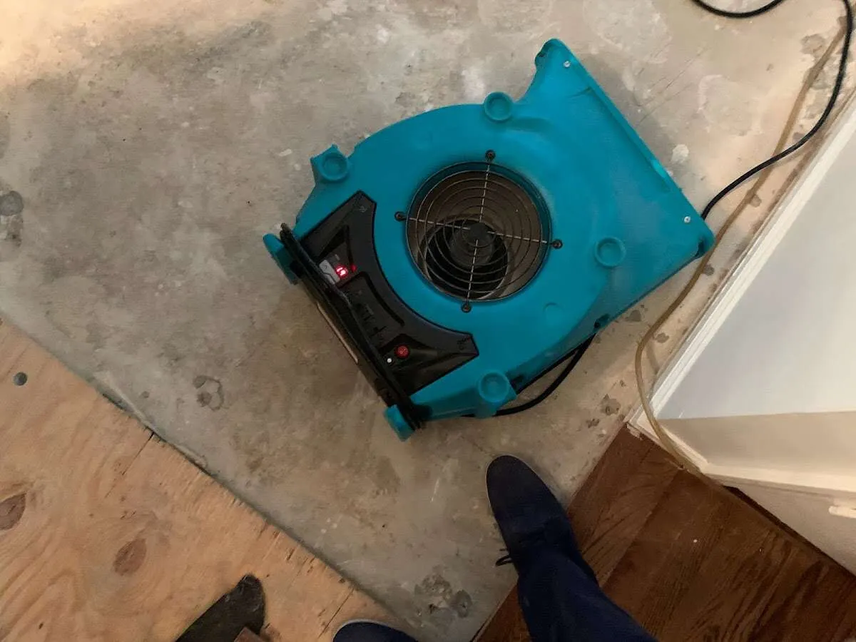 Air mover drying subfloor during Commercial Water Damage Restoration in Falls